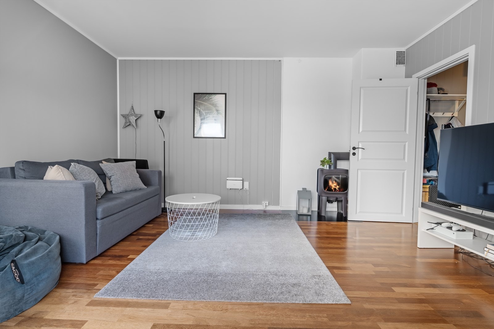 Stuen i 2-romsen er tilnærmet kvadratisk og har peisovn for ekstra varme og hygge. Galleribilde