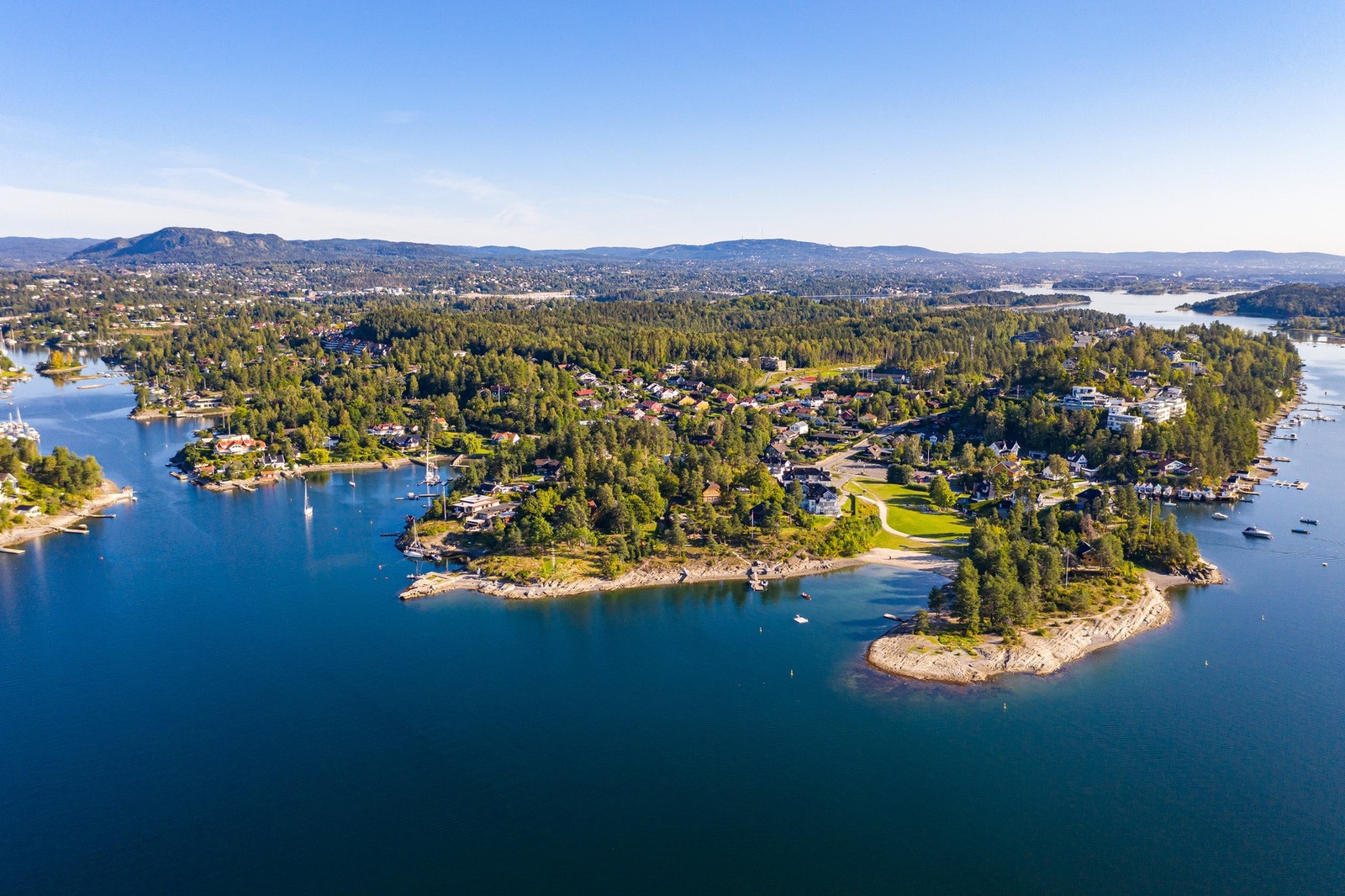 Flyfoto mot sydvestre ende av Nesøya med badestranden og friområdene ved Hvamodden i front Galleribilde