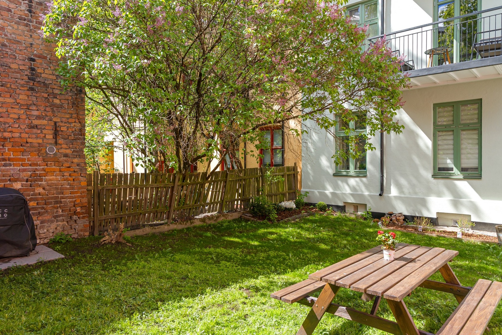 Pent opparbeidet og skjermet felles bakgård med sittegruppe. Galleribilde