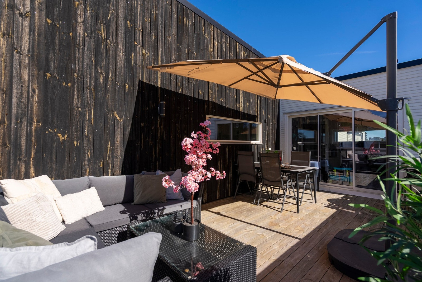 En terrasse som gir rom for både loungemøbler og spisemøbler, perfekt for sosiale sammenkomster og avslapning Galleribilde