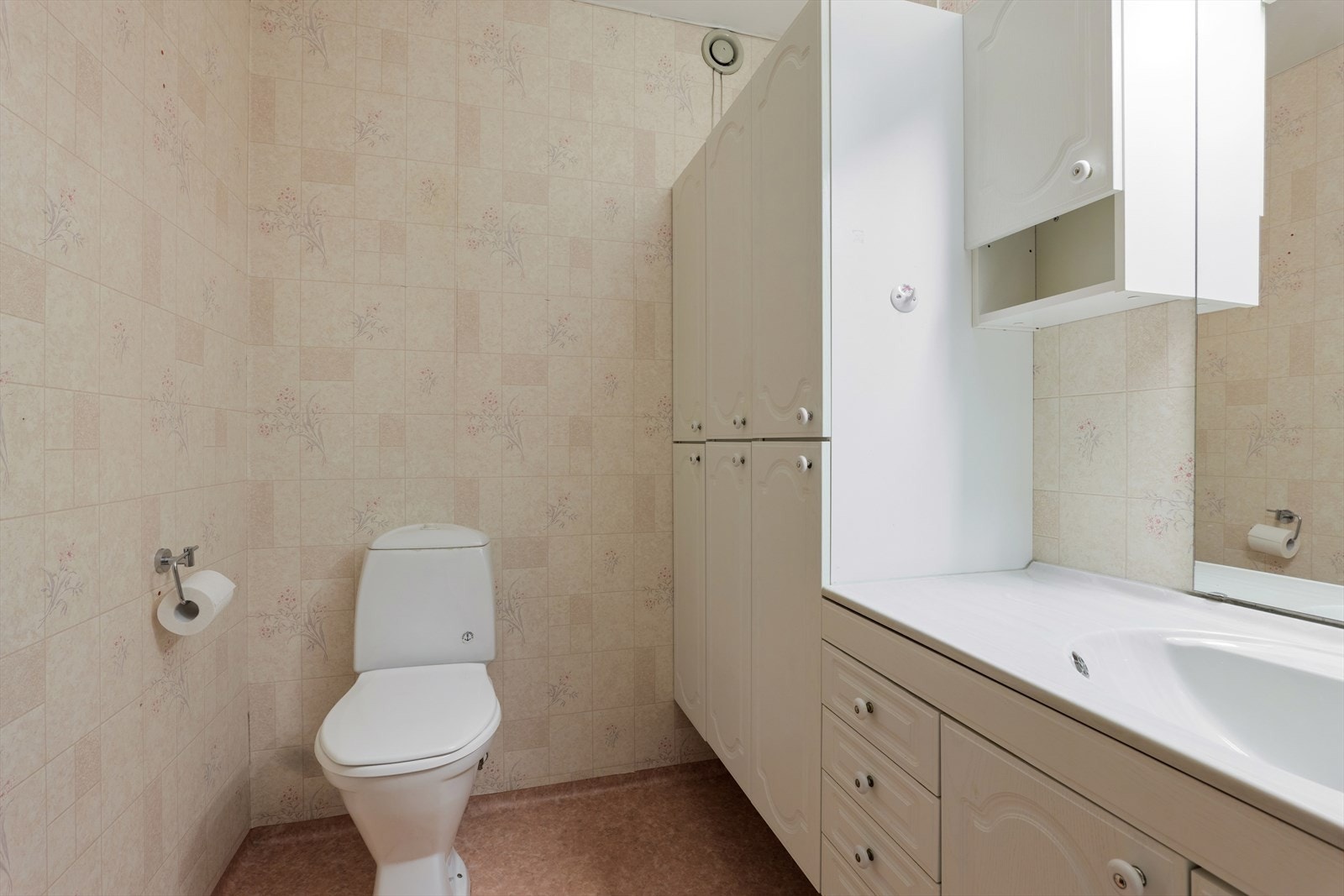 Badet har belegg på gulv og baderomstapet på vegger. Galleribilde
