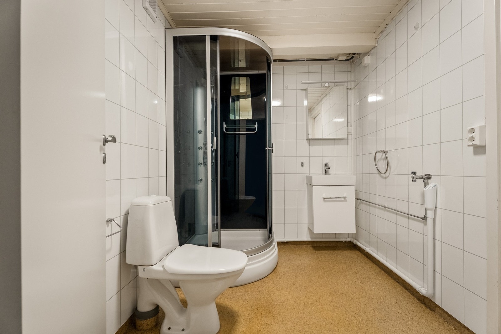 Badet er innredet med våtromsplater på veggene og perginolbelegg på gulvet. Galleribilde