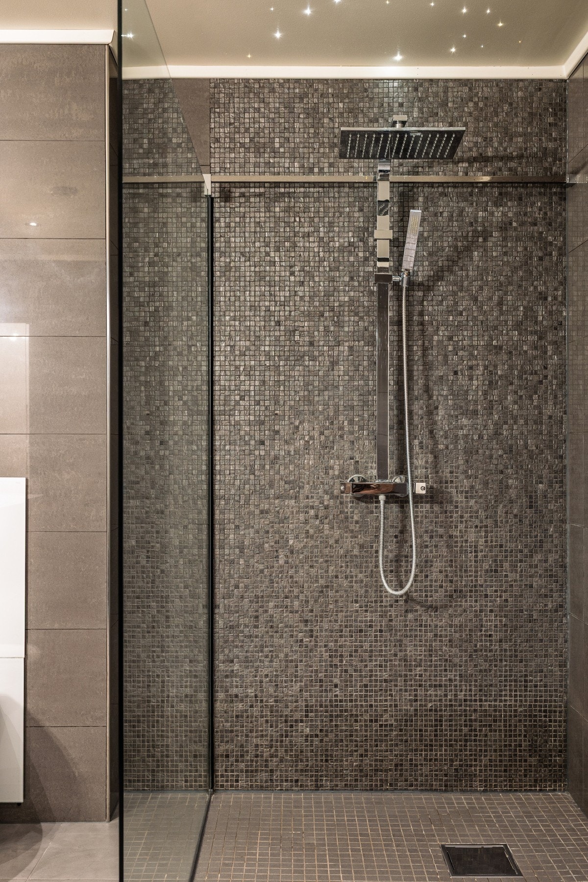 Stor dusjnisje med stjernehimmel gir badet et eksklusivt preg og skaper en spa-lignende følelse. Galleribilde