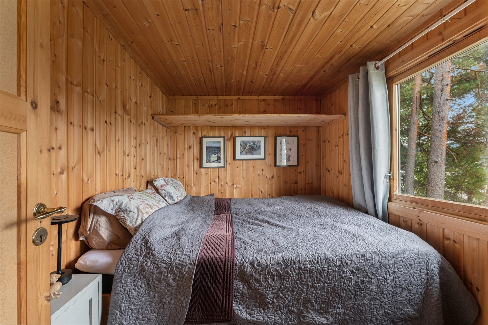 Soverom med varme treflater og fin utsikt mot skogen. Galleribilde