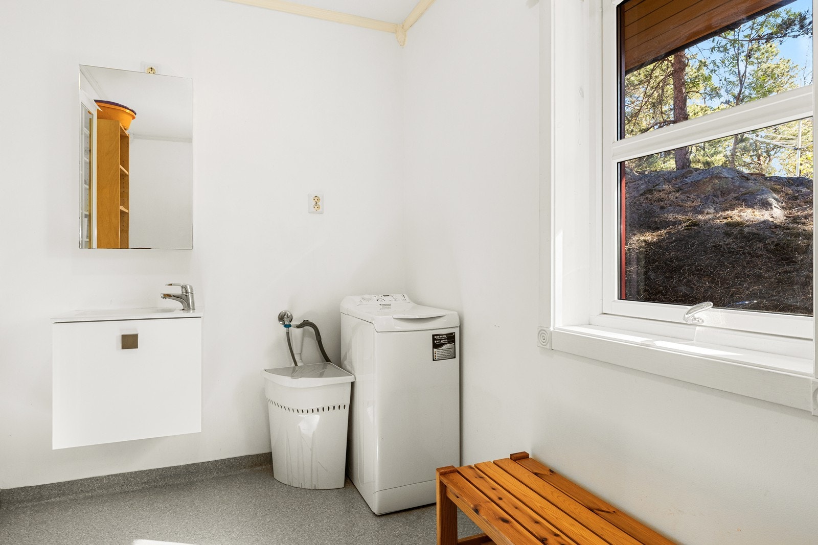 Videre er det servant med tilhørende speil, samt opplegg for vaskemaskin. Galleribilde