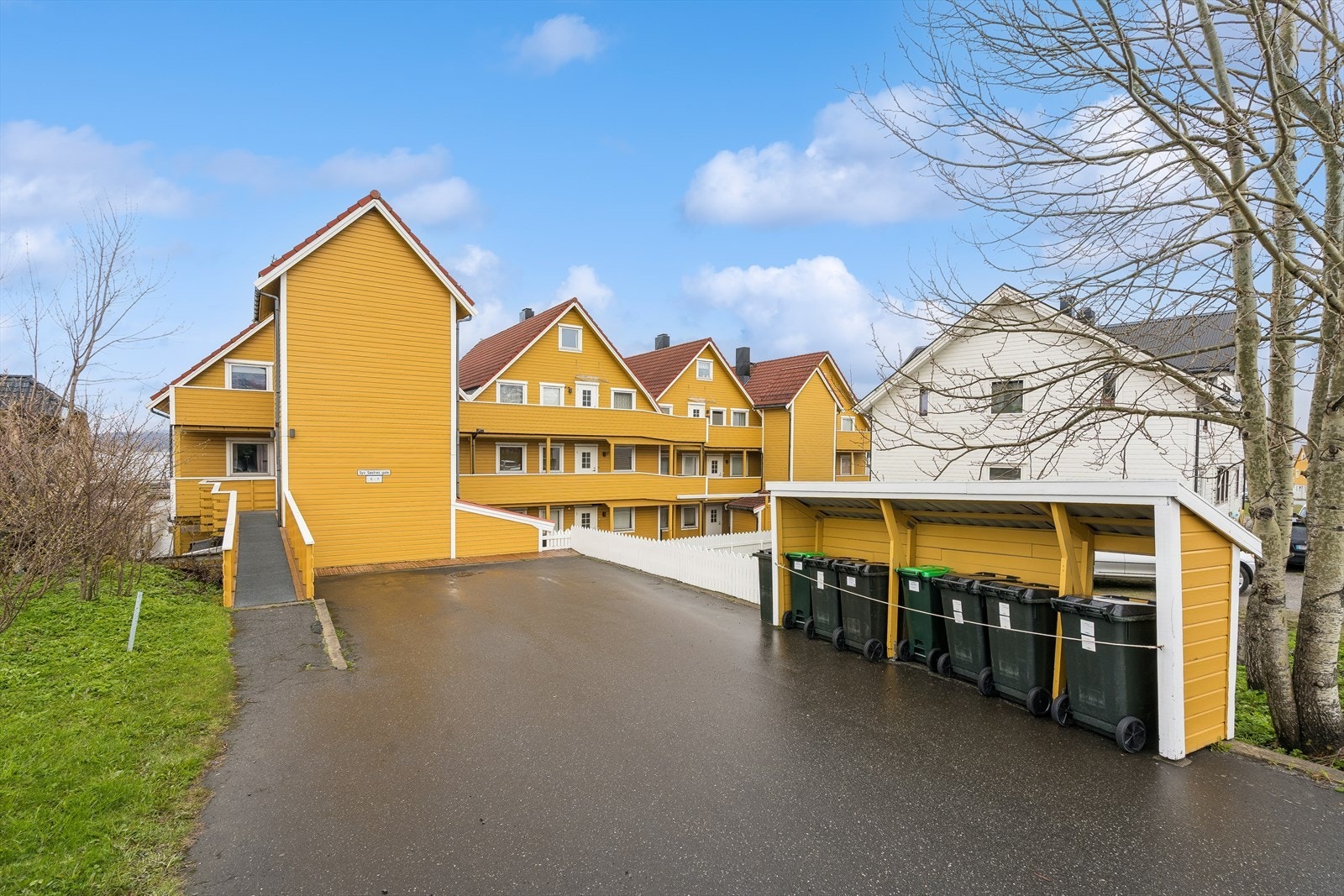 Det er to trappehus i sameiet, og ved veien er det bygd en levegg for søppelboksene. Galleribilde