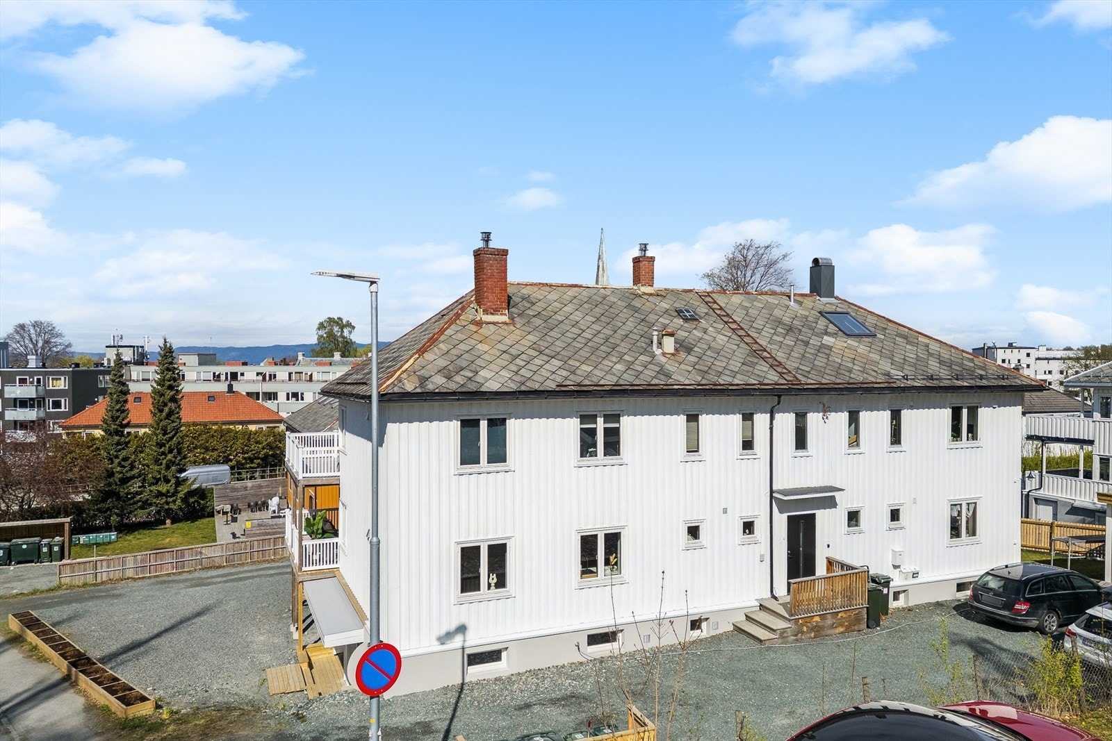 Sameiets eide tomt på 996,1 m². Felles uteområde består av plen og gruset parkeringsareal. Galleribilde