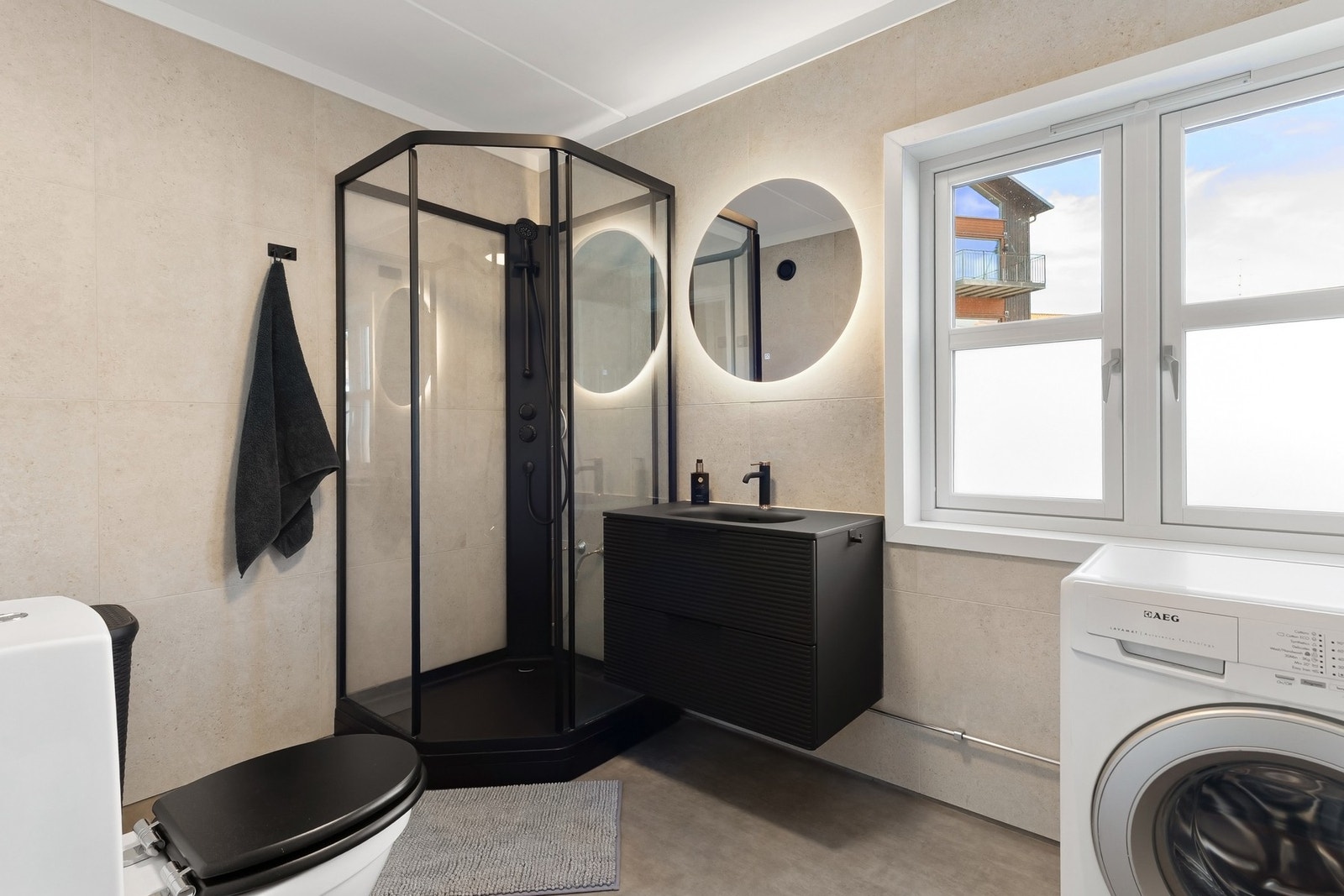 Flott bad med fliser på vegg som er innredet med servantskap, dusjkabinett og wc. God plass til vaskemaskin. Galleribilde
