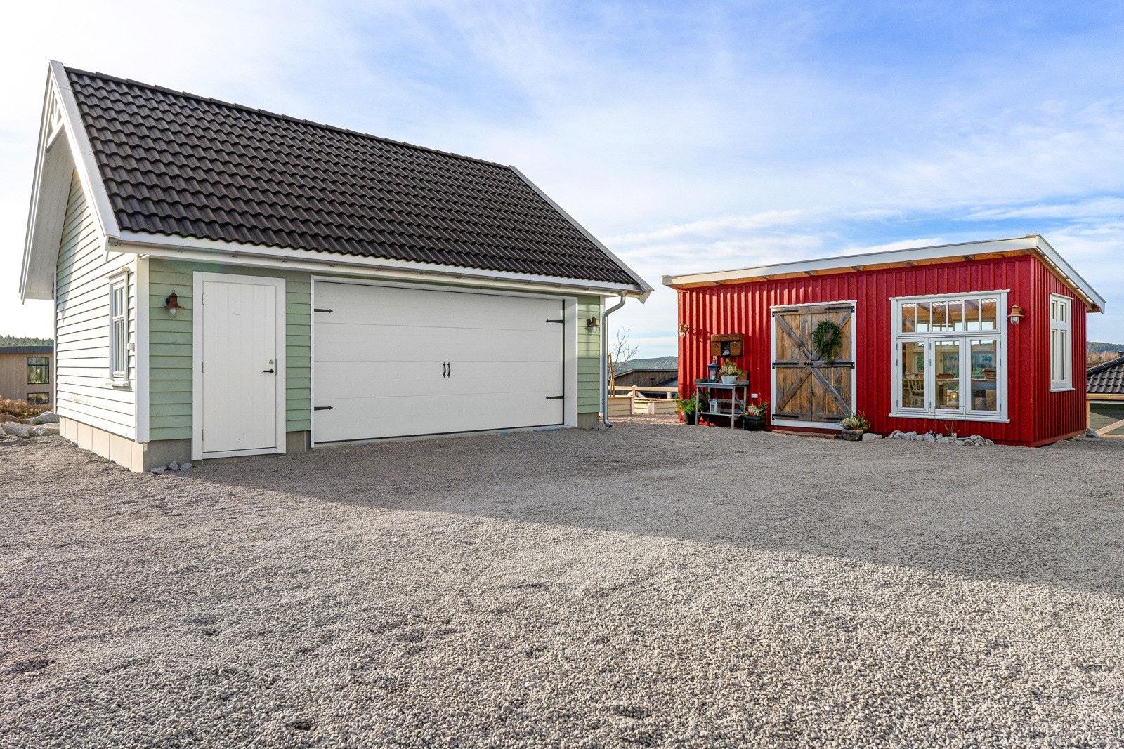 Dobbel garasje med trapp opp til lagring, og hagestue med snekkerbod. Galleribilde
