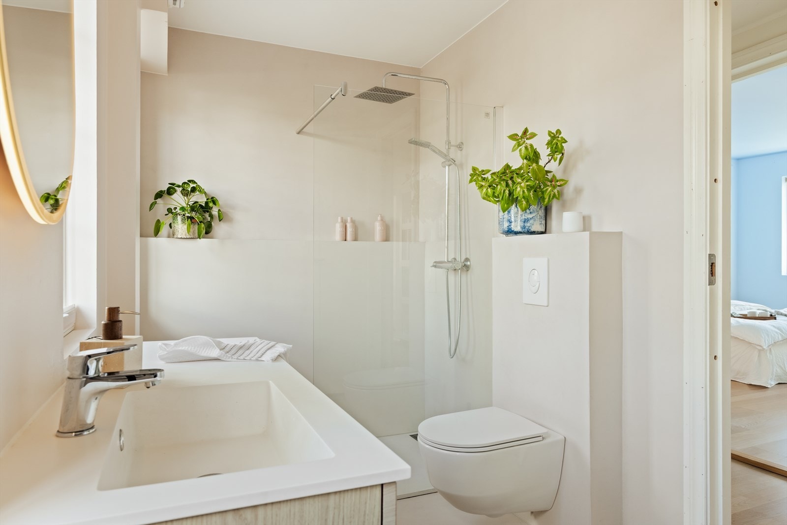 Badet er utstyrt med dusjnisje, vegghengt toalett og baderomsinnredning med heldekkende servant og belyst speil. Galleribilde