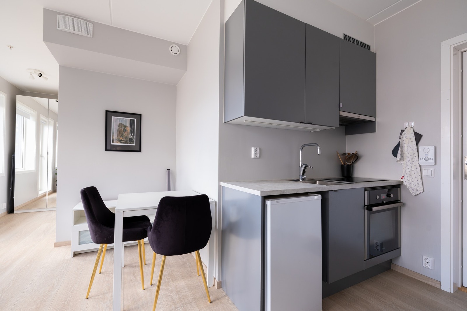 Kjøkkeninnredningen har fabrikklakkerte glatte fronter og laminat benkeplate med nedfelt oppvaskkum. Galleribilde
