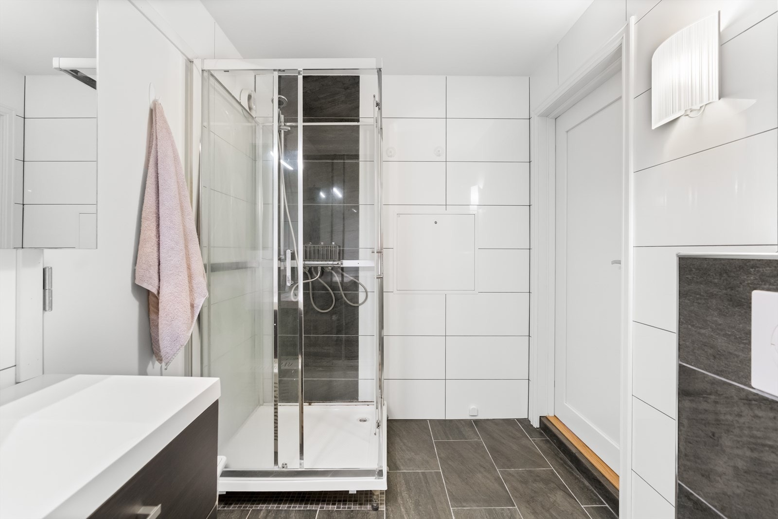 Videre har badet et vegghengt toalett, et dusjkabinett og opplegg for vaskemaskin. Galleribilde