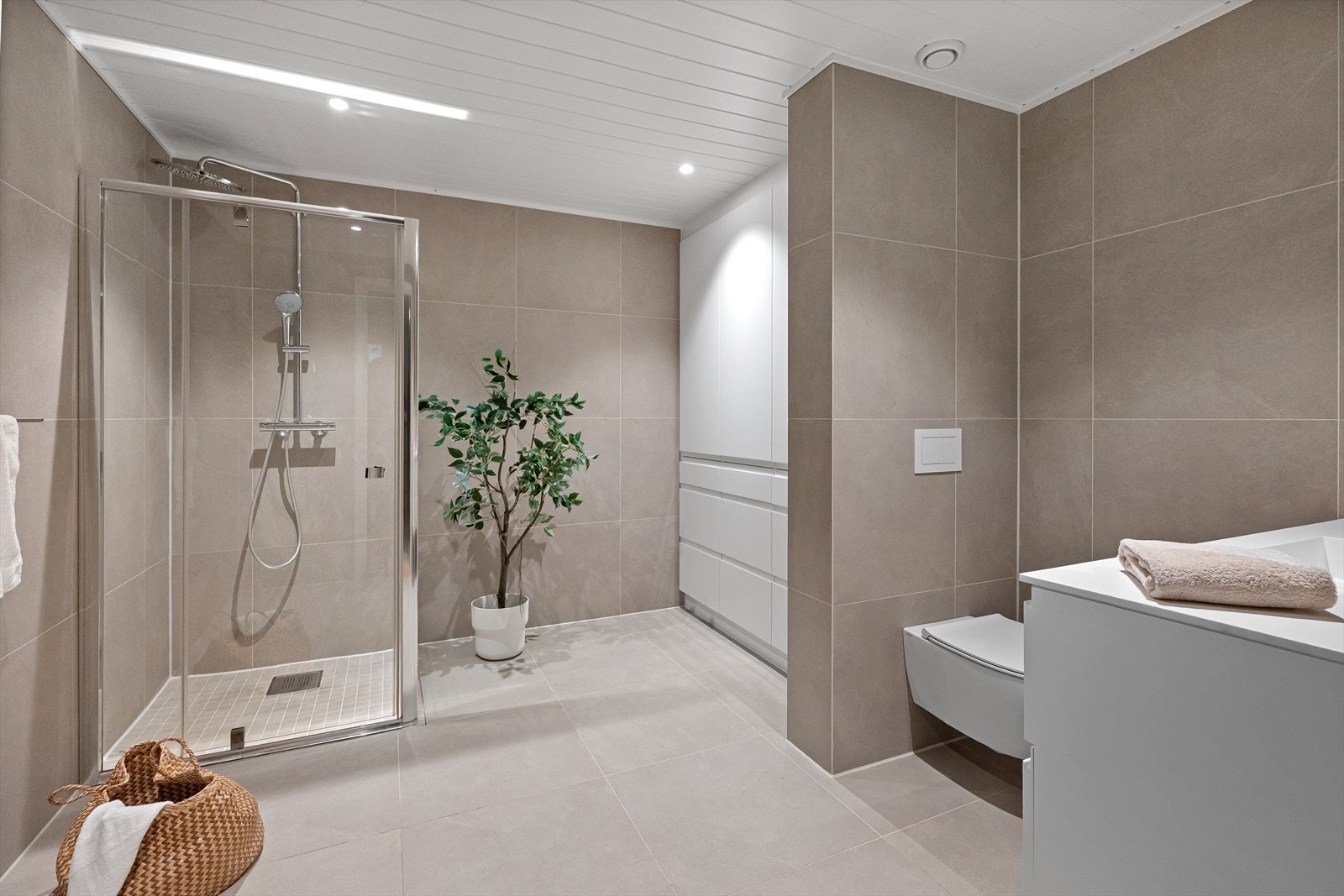 Badet har en romslig dusjnisje med glassdører. Galleribilde