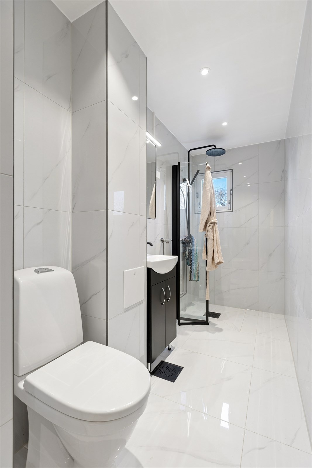 Badet ble oppgradert i 2026 med flis-på-flis, ny baderomsinnredning og elektriske varmekabler i gulvet. Galleribilde