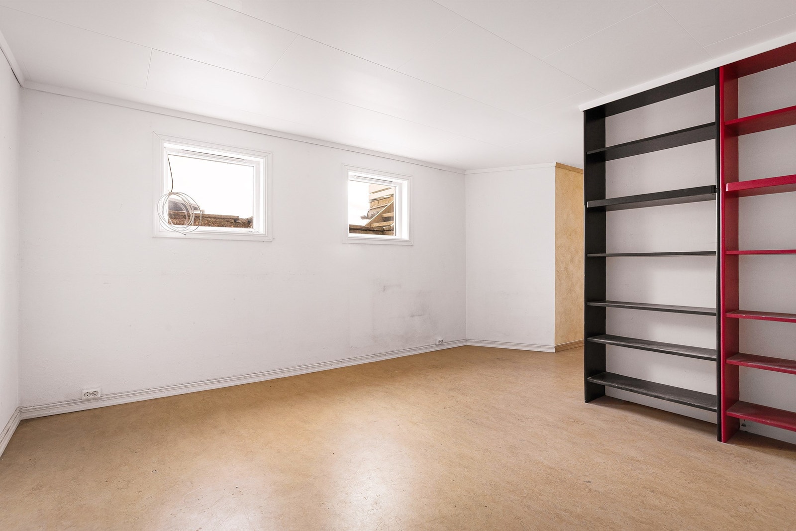 God plass til sofagruppe og to vinduer stue del i hybel rommet. Galleribilde