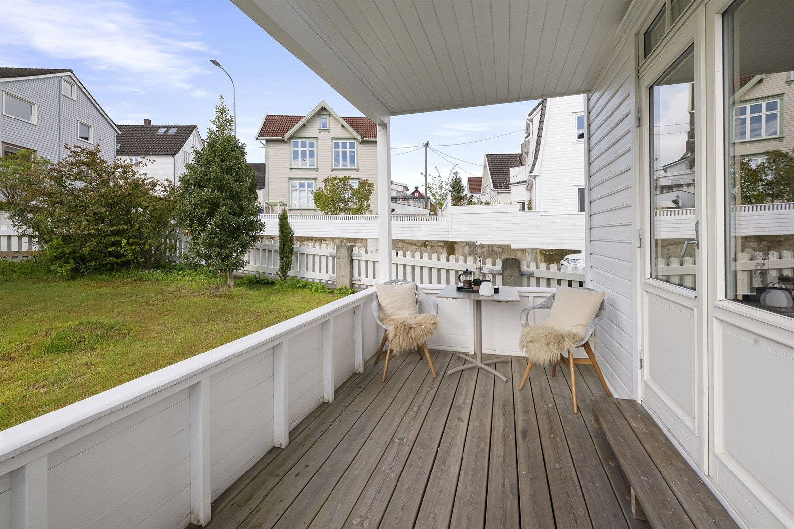 Den overbygde terrassen i første etasje gir en lun uteplass med utsikt over hagen. Galleribilde