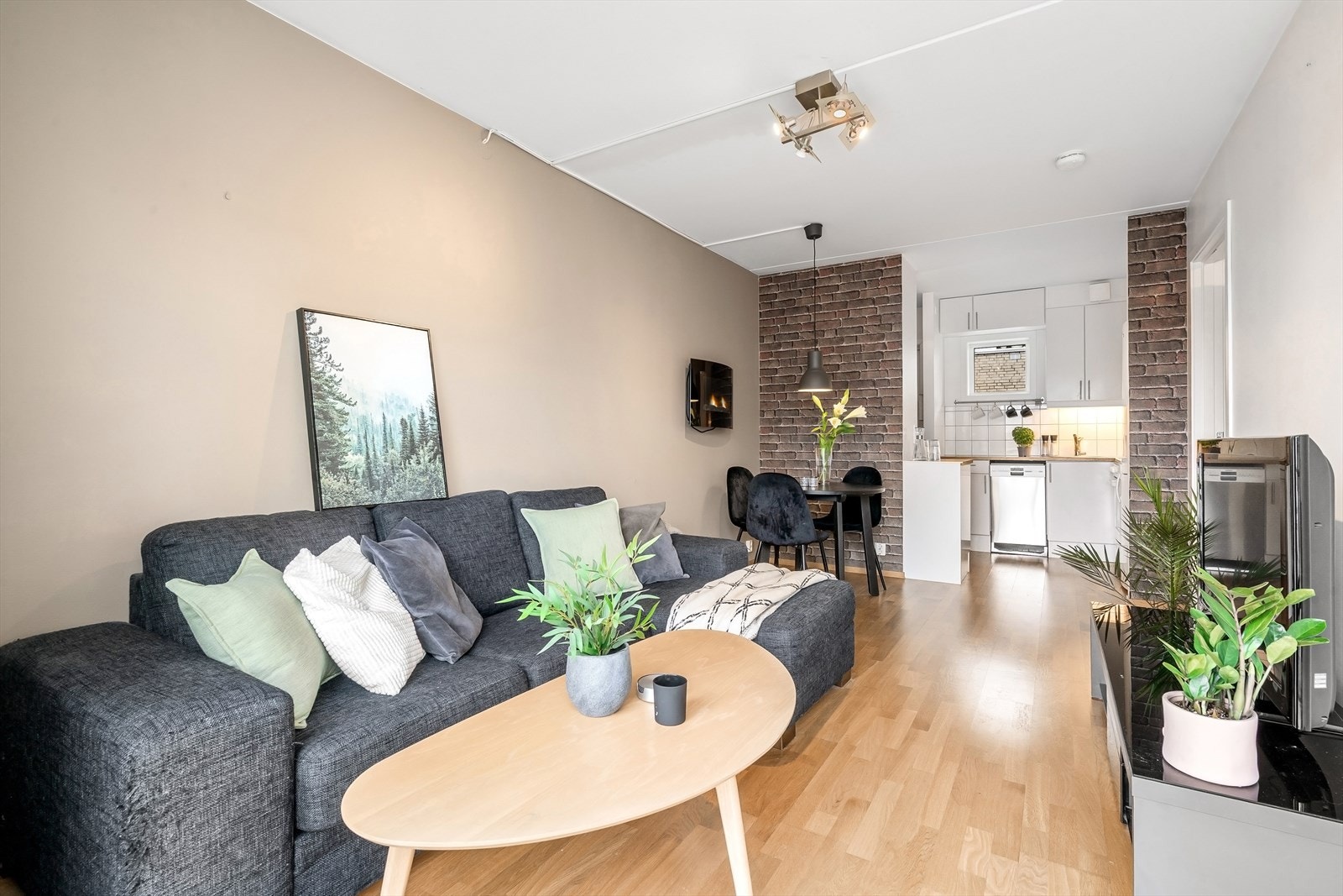 Stuen har en lys fargepalett, parkettgulv og har plass til å møblere med både spisebord og sofagruppe. Galleribilde
