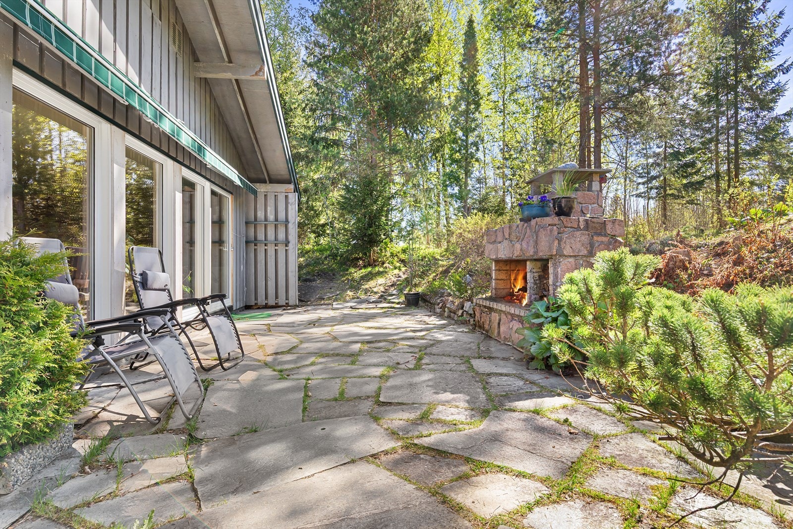 Skiferlagt uteområde som virkelig har et ypperlig potensiale for usjenerte og lune sommerdager Galleribilde