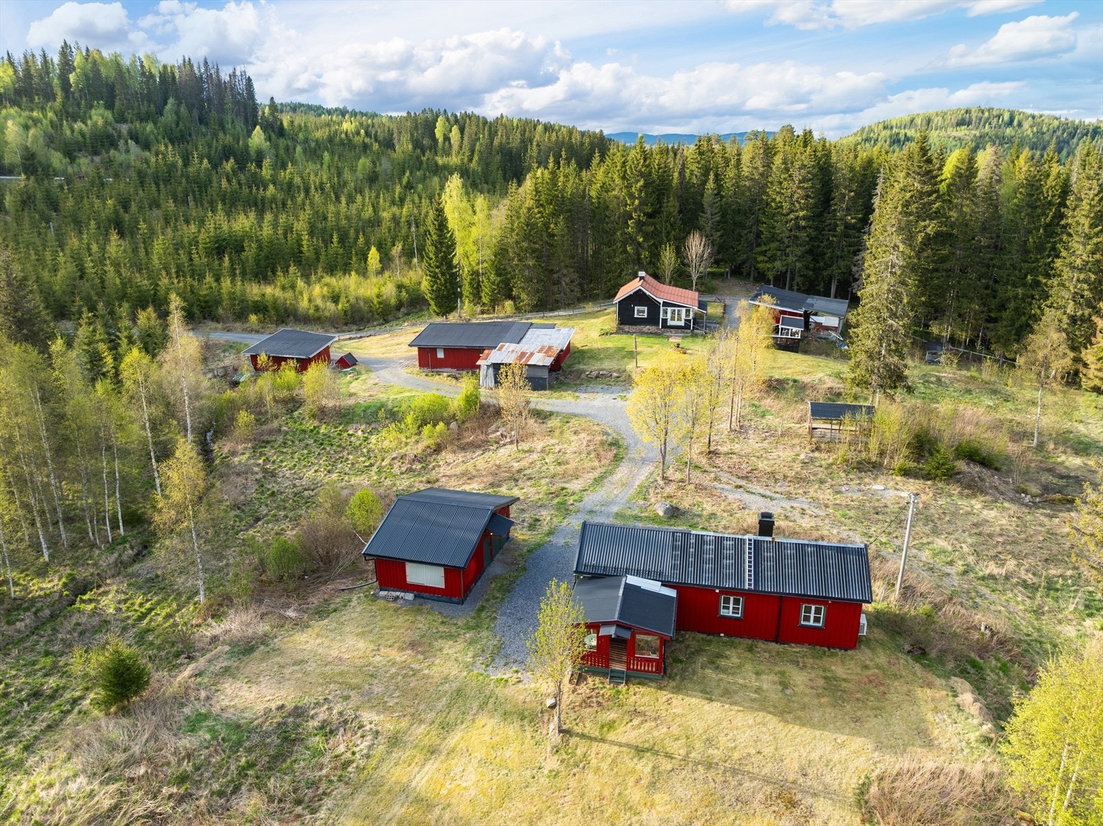 Oversikt over tunet med de to eneboligene og flere av uthusene. Galleribilde