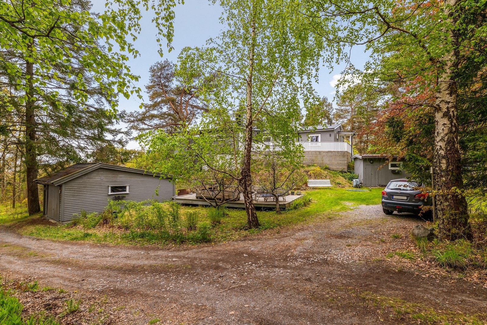 Gruset gårdsplass med parkering og adkomst til garasjen. Galleribilde