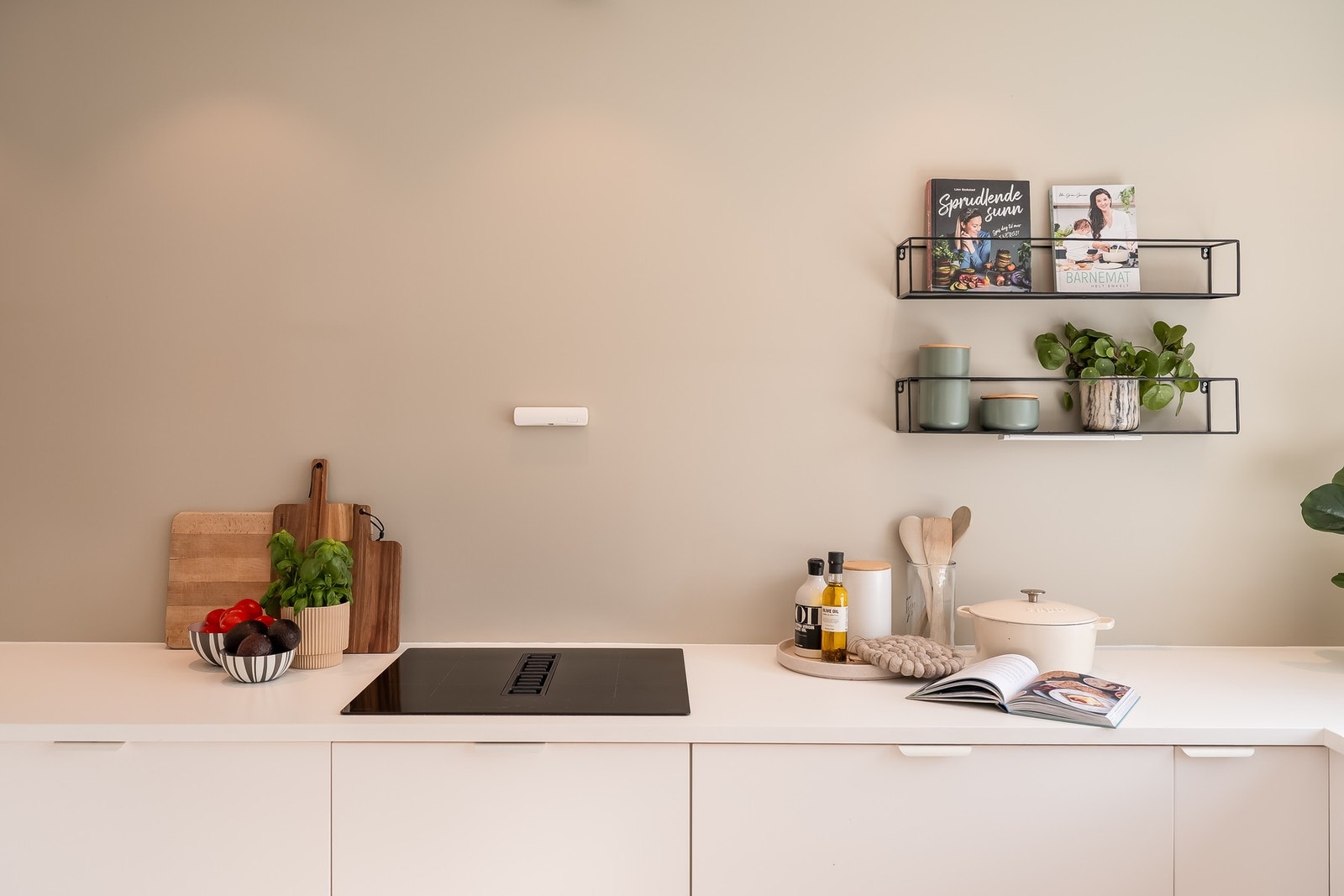 Kjøkkenet er utstyrt med platetopp med integrert ventilator for både praktisk funksjon og elegant design. Galleribilde