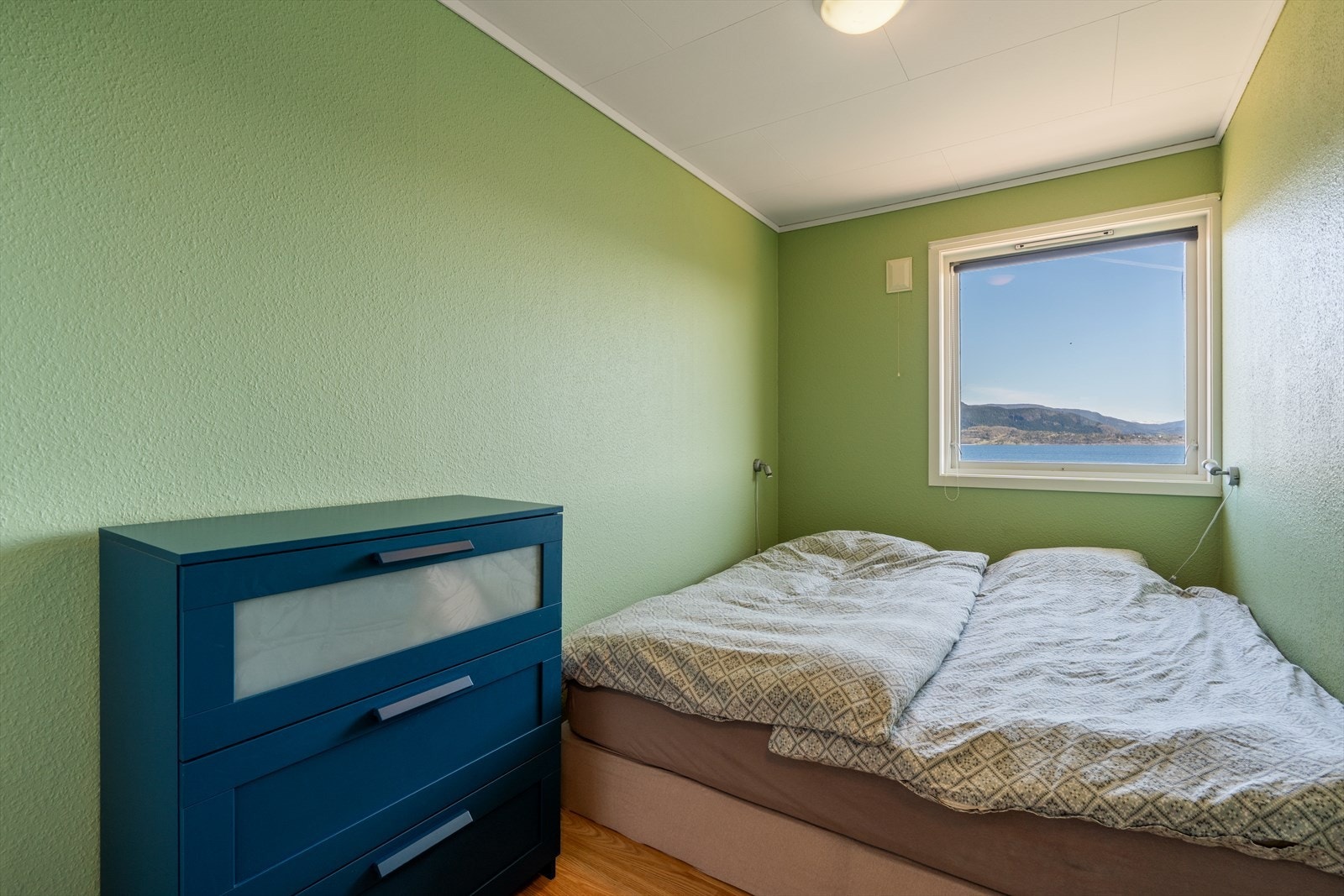 Ett av to soverom i første etasje, begge med utsikt mot sjøen. Galleribilde