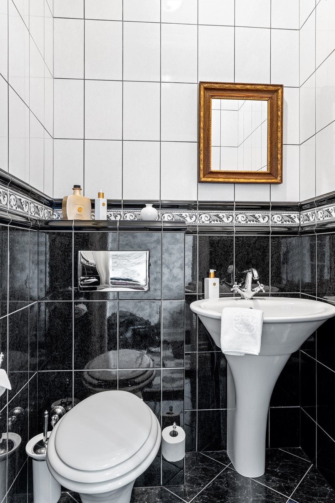 Fra yttergangen er det adkomst til eget gjestetoalett med fliser på vegger og gulv. Flott søylevask og WC fra Hatria Galleribilde