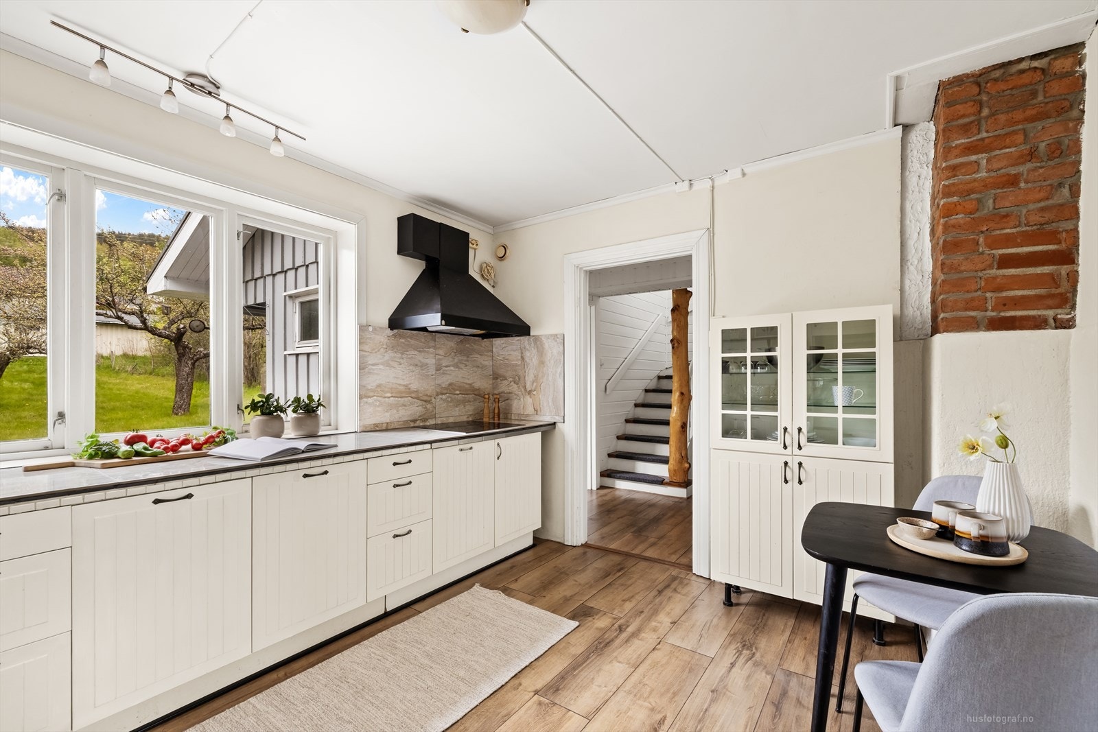 Kjøkkenventilator med avtrekk ut sikrer god utlufting. Fra kjøkkenet er det åpent inn mot hallen. Galleribilde