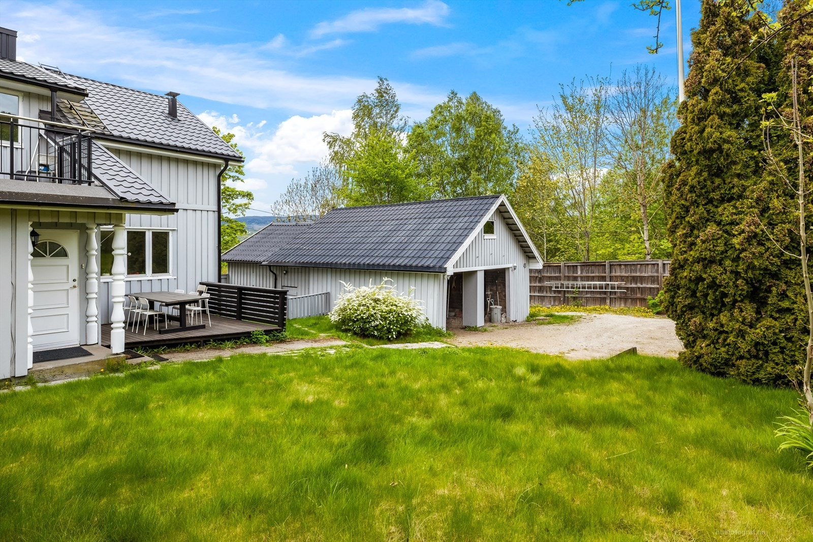 På eiendommen står en romslig garasjebygning med plass til parkering og lagring. Galleribilde