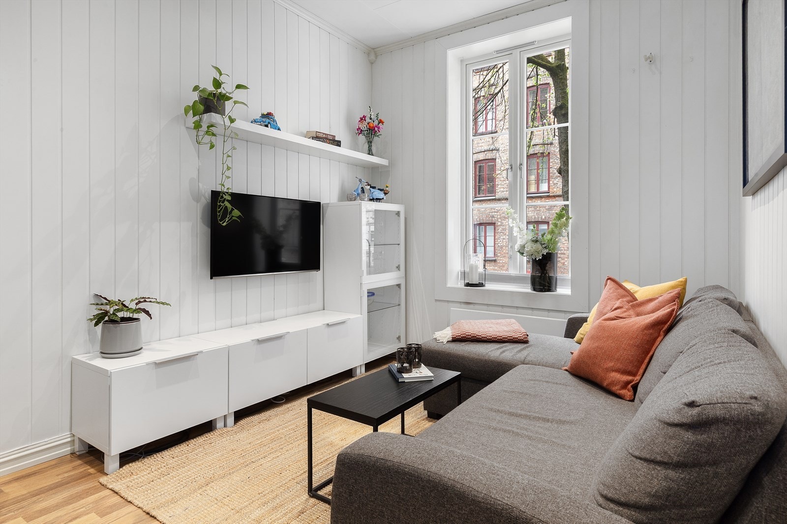 Stue med romhøyde målt til ca. 2,85 meter og plass til både sofa og oppbevaring Galleribilde