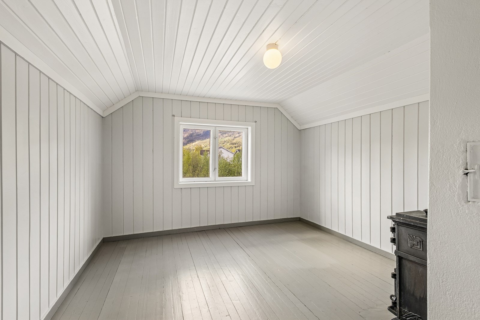 Ett av to soverom på loftet har vedovn. Galleribilde
