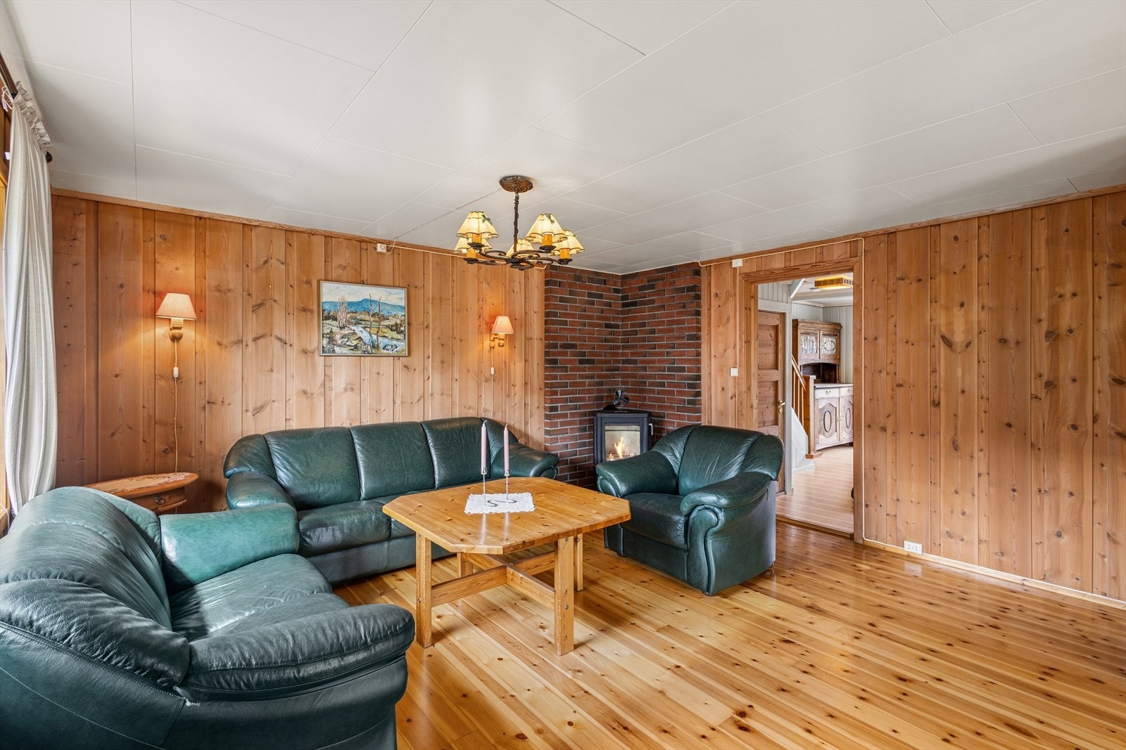 Stuen har god plass til sofagruppe. Veggene har panel, og på gulvet er det tregulv. Galleribilde