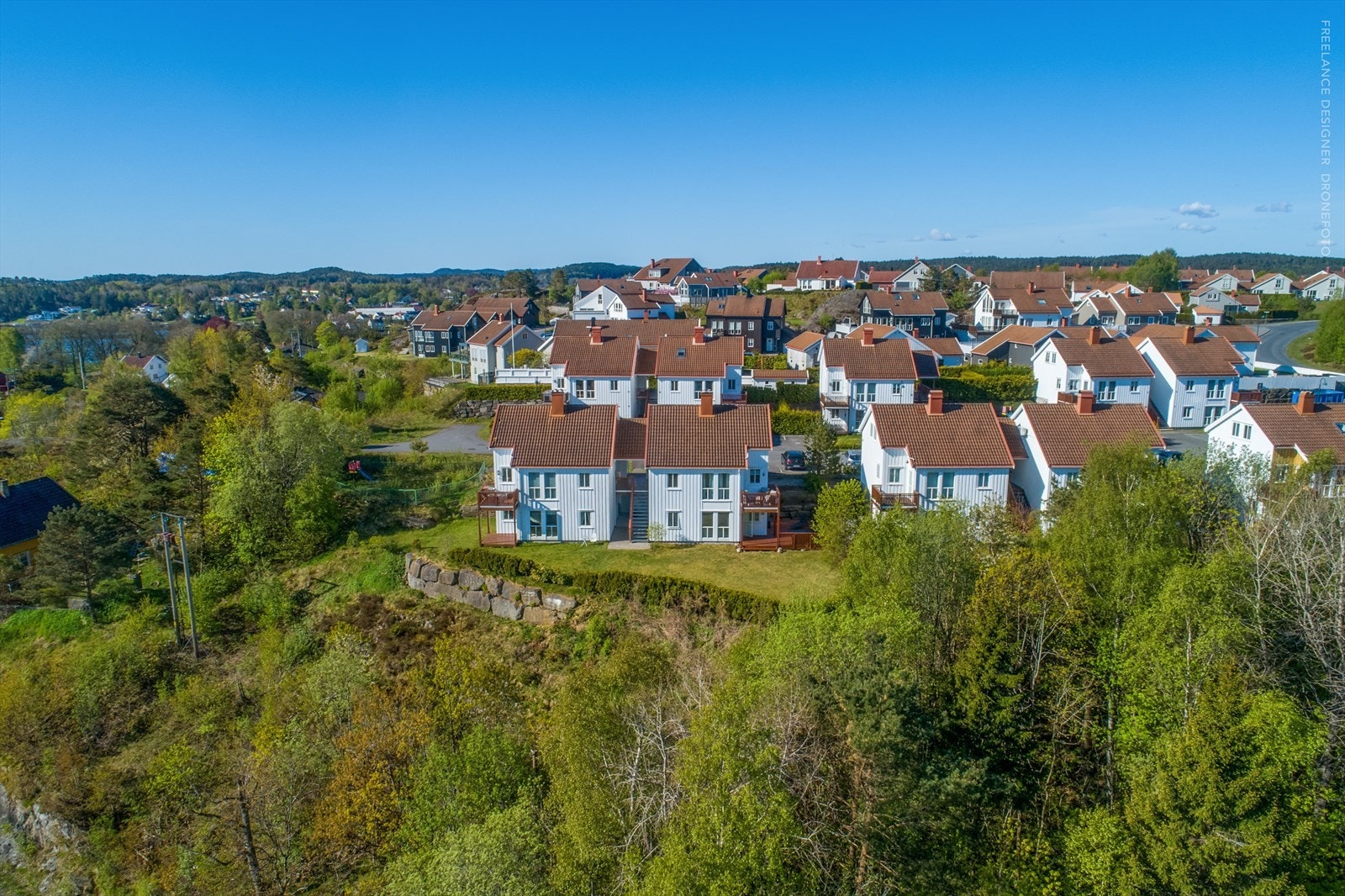 Tomten er opparbeidet med plener og beplantning samt noe naturtomt. Galleribilde
