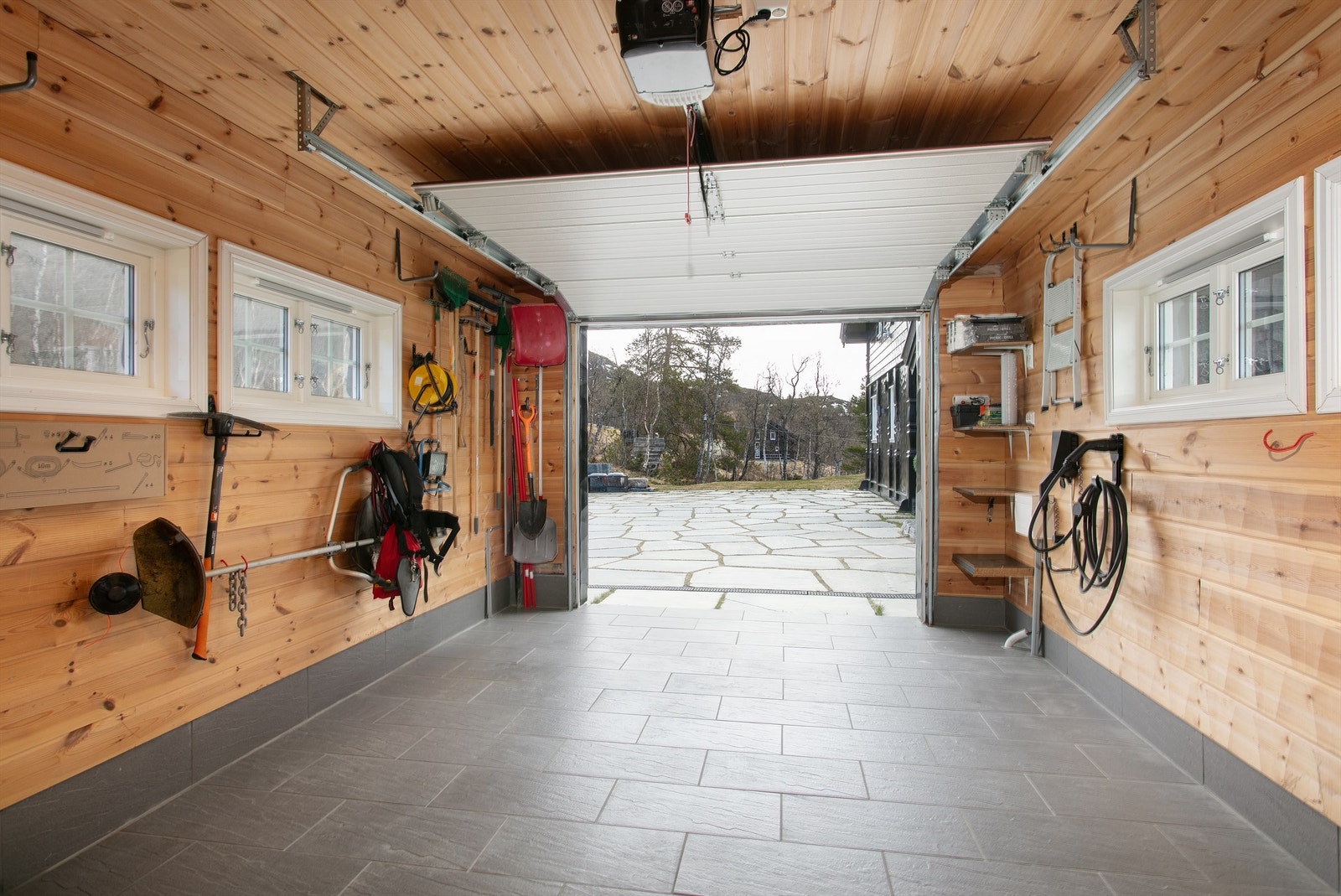Fra garasjen er det direkte utgang til den skiferbelagte gårdsplassen. Galleribilde