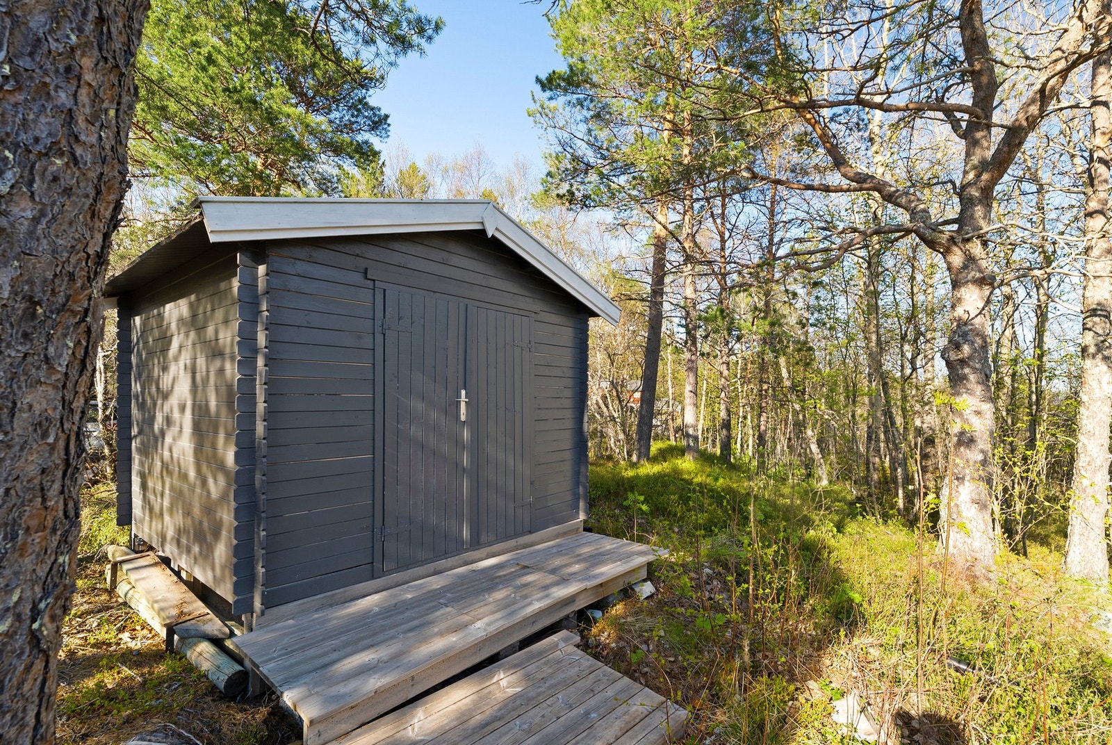 Egen utebod på tomten gir praktisk lagringsplass for utstyr og ved. Galleribilde