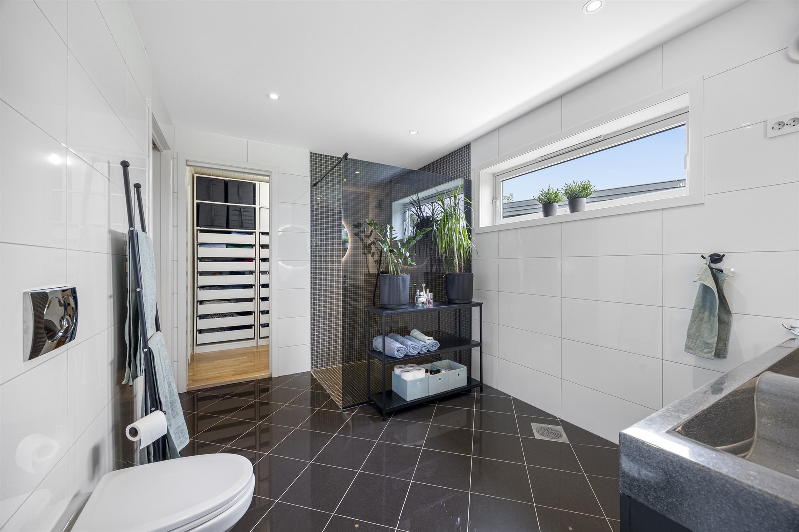 Fra badet er det tilkomst til garderobe og videre inn til vaskerom (vaskerom har tilgang fra gangen og utvendig i tillegg) Galleribilde