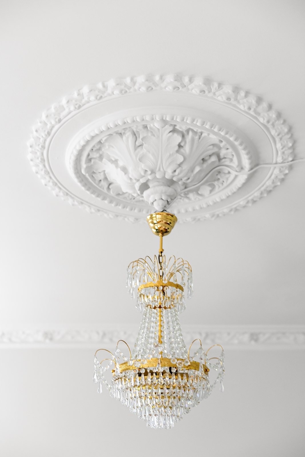 Klassiske detaljer som stukkatur og rosetter understreker leilighetens eleganse. Galleribilde