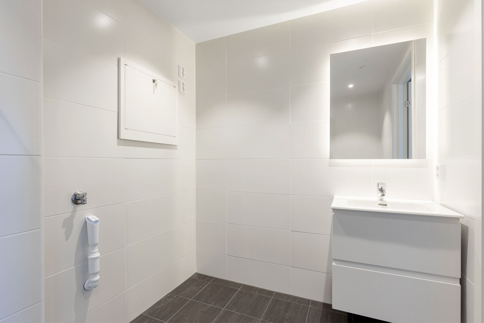Badet har opplegg for vaskemaskin. Galleribilde