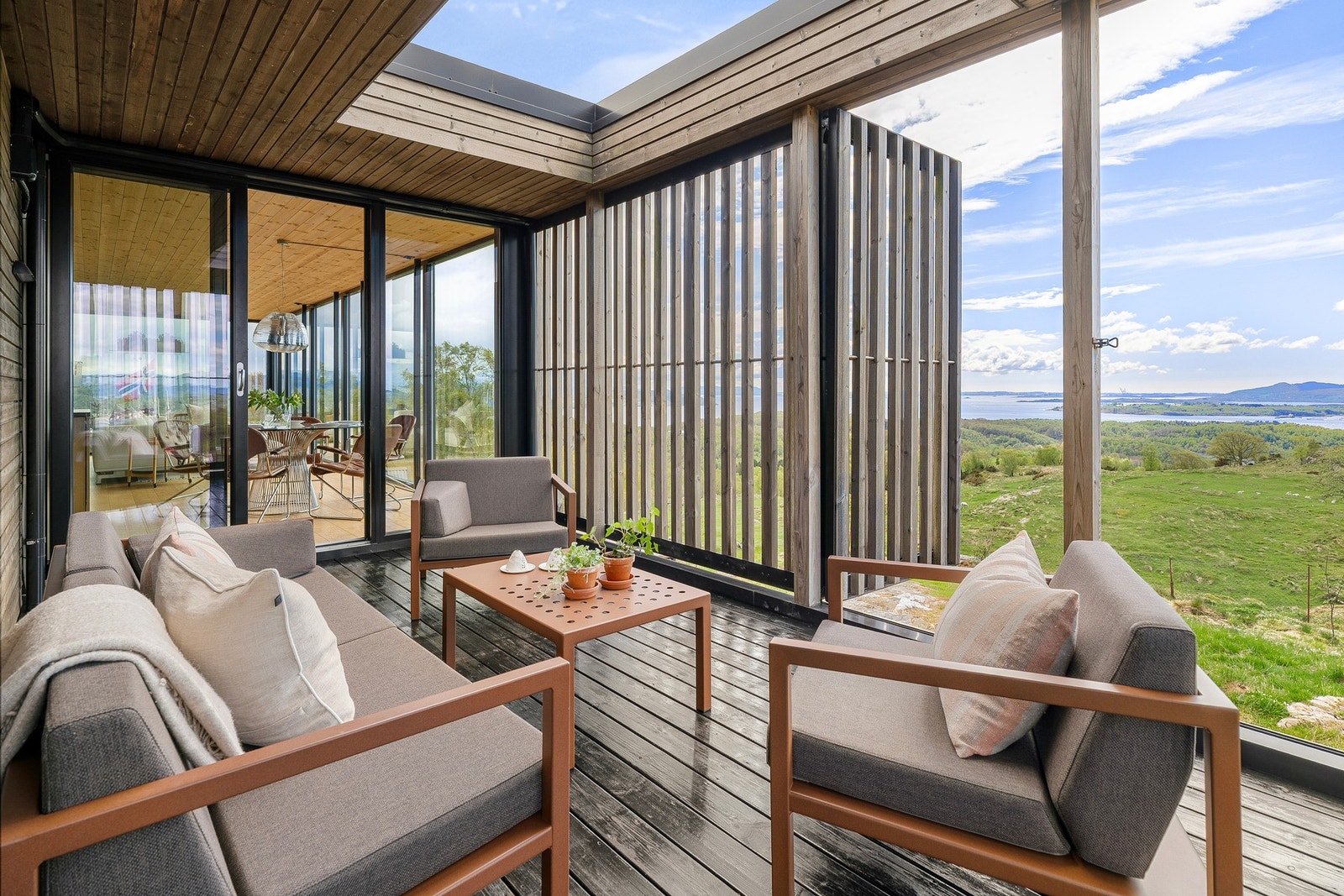 Utsikten kommer til sin rett både fra tomten og innsiden, og ute kan man blant annet sitte usjenert på en vestvendt, dels overbygd terrasse med adkomst fra stue/kjøkken. Galleribilde