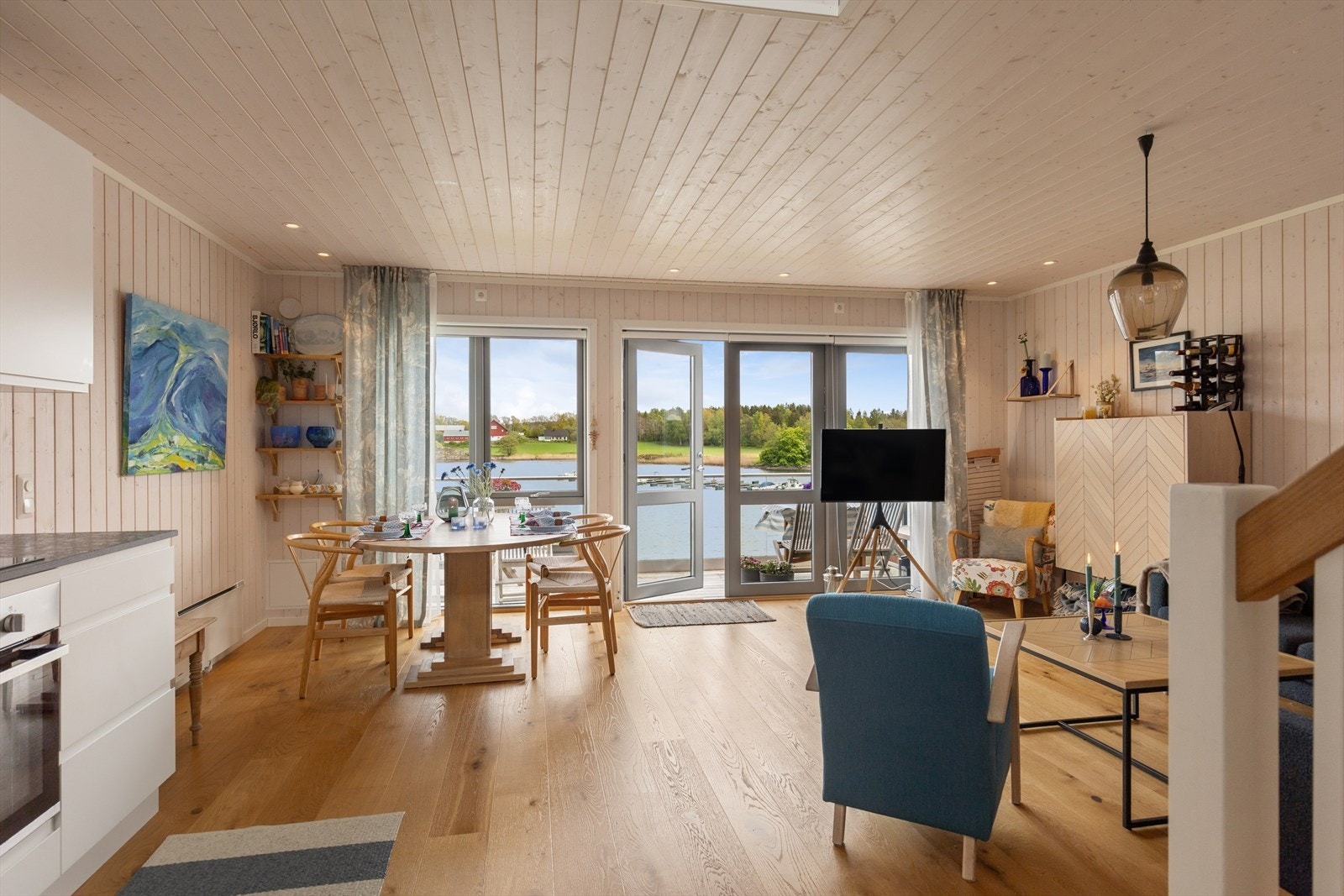 Åpen løsning mellom stue og kjøkken skaper en luftig og sosial sone. Fra stuen er det utgang til terrasse. Galleribilde