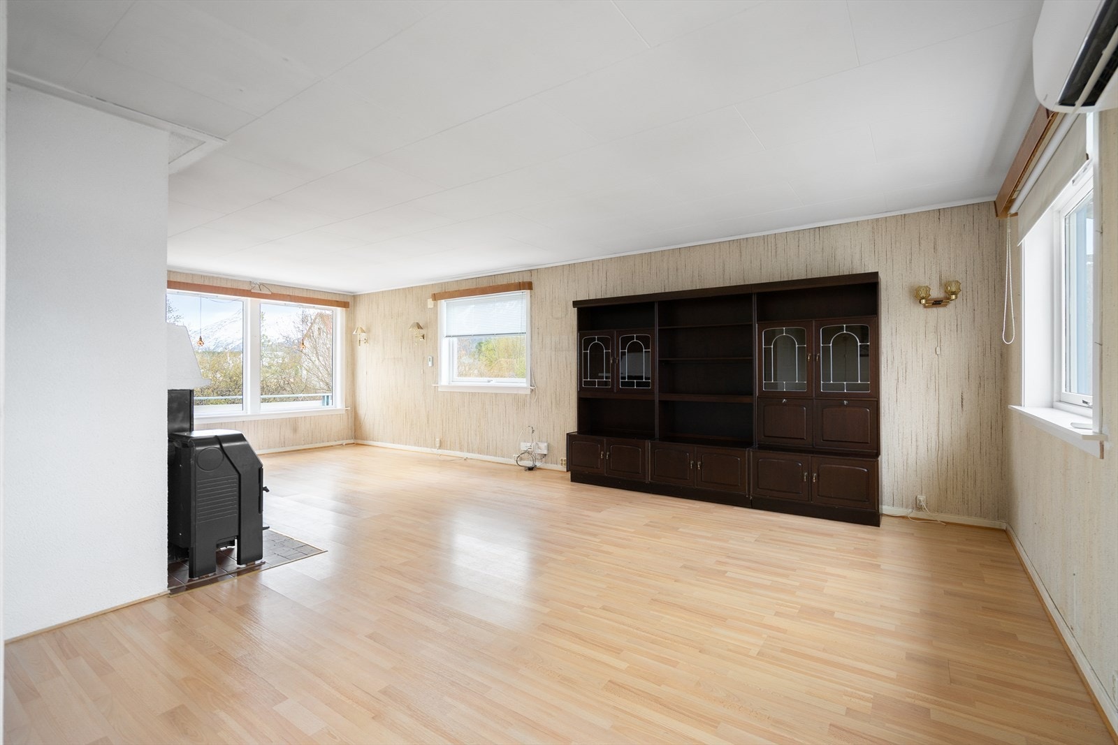 Stor stue med flere store lysflater som slipper inn rikelig med dagslys. Galleribilde