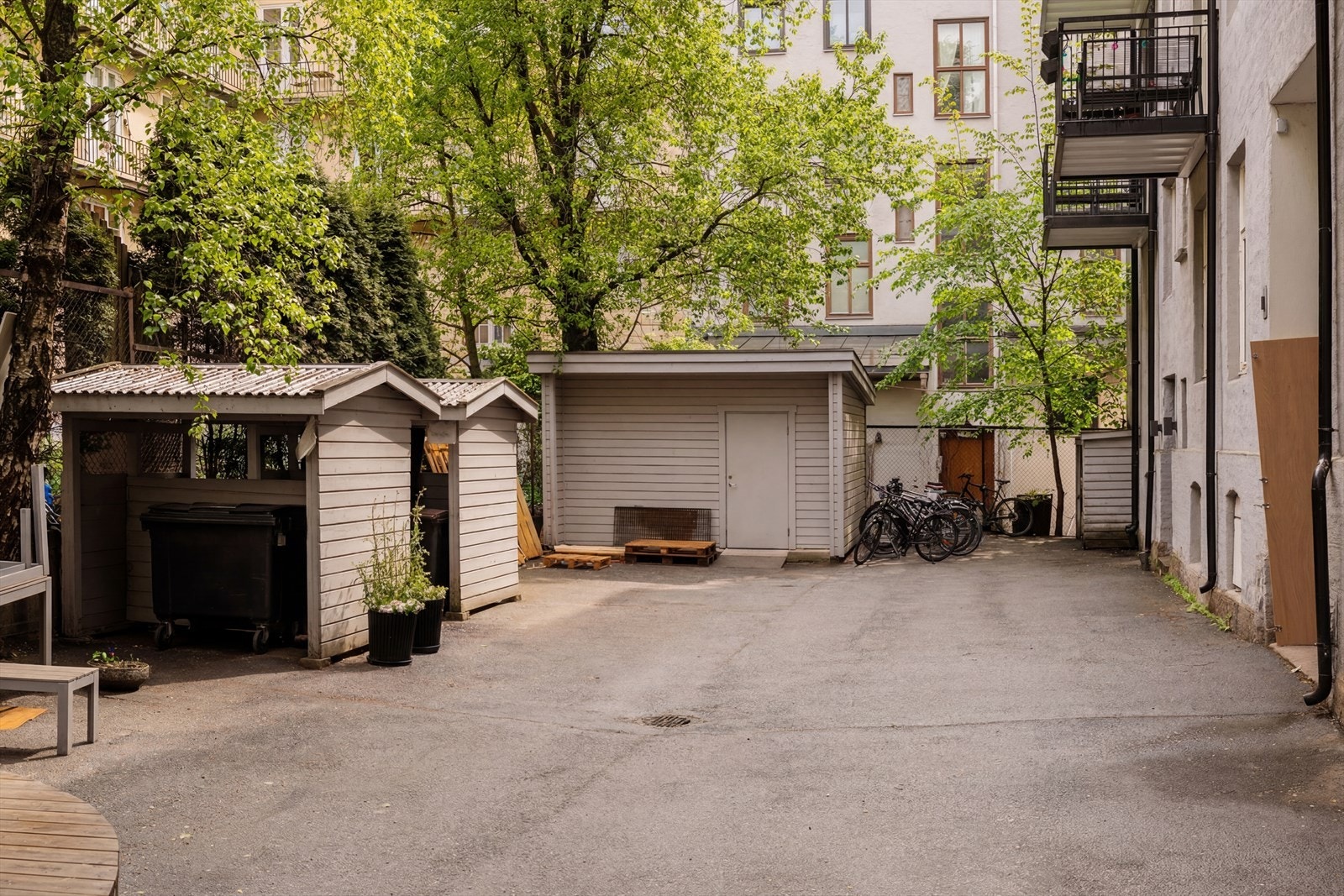 Borettslaget har en skjermet og hyggelig bakgård med sykkelparkering. Bildet er AI redigert. Galleribilde