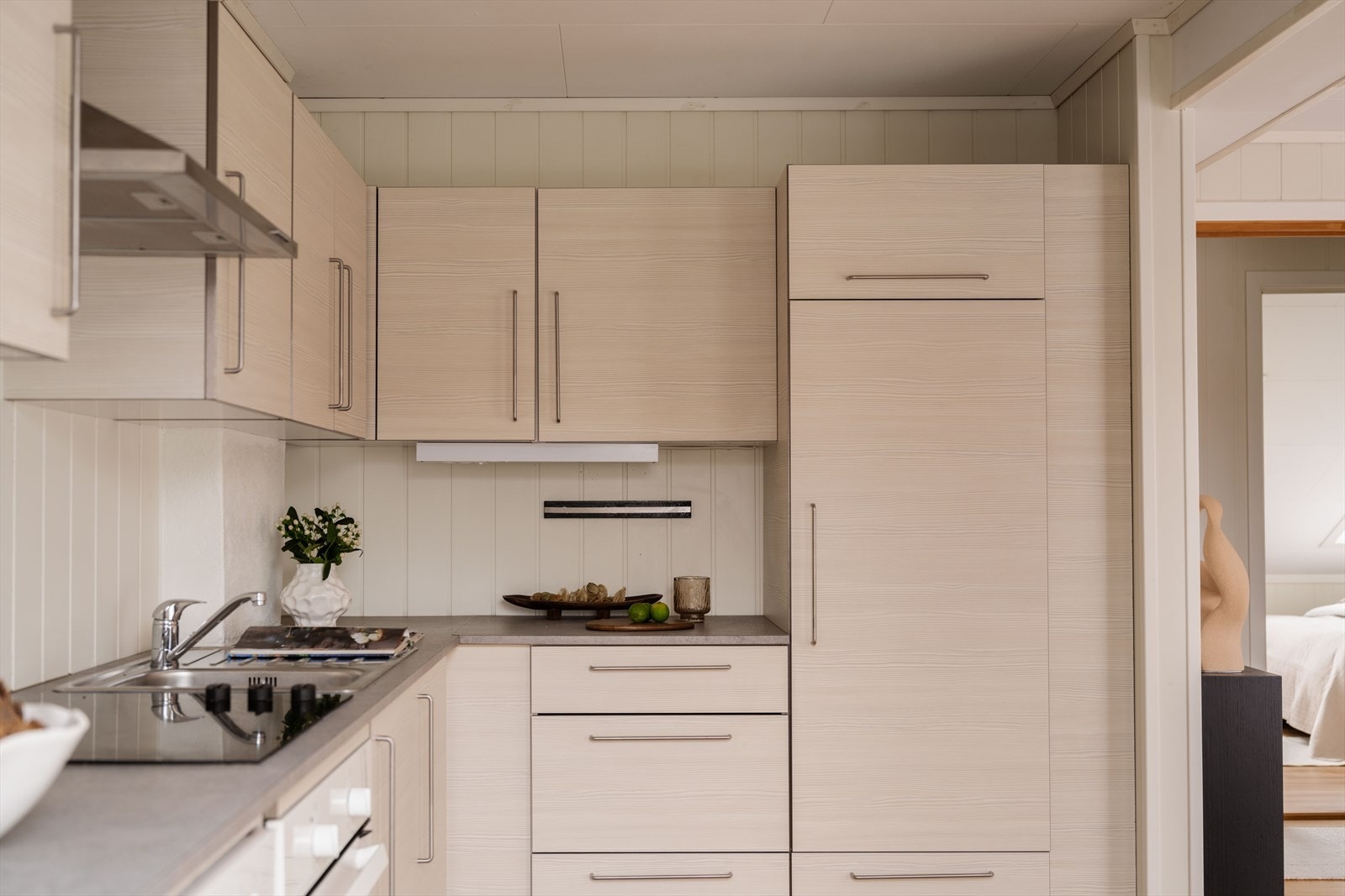Kjøkkeninnredningen fra Ikea har et delikat og tidløst uttrykk med slette fronter og laminat benkeplate med nedfelt oppvaskkum. Galleribilde