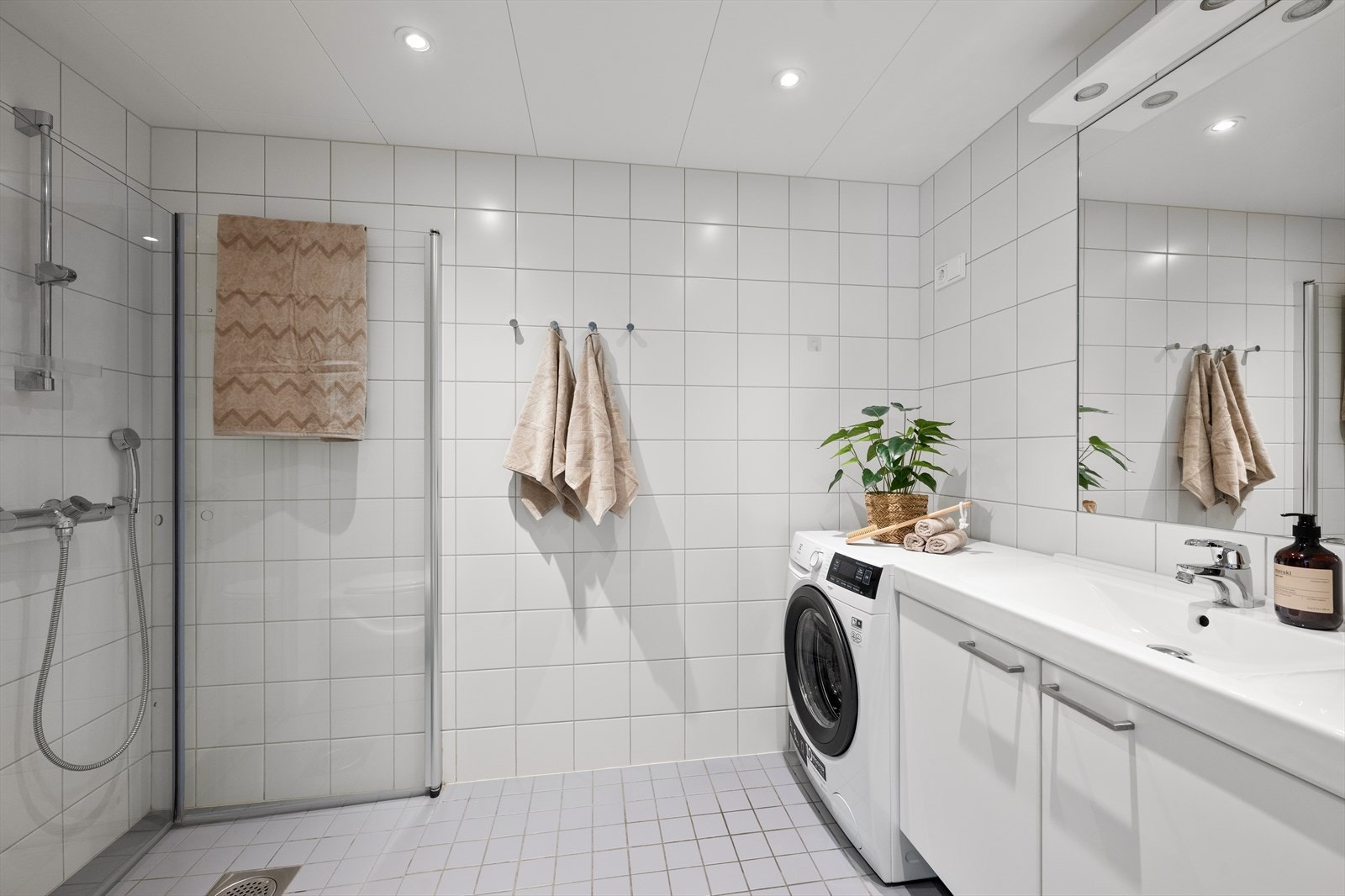 Delikat og moderne bad med flislagte overflater og varmekabler Galleribilde