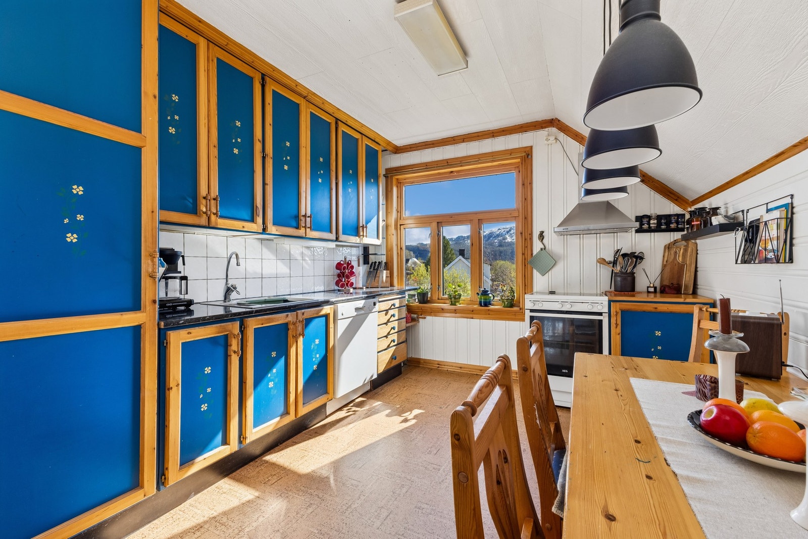 Kjøkken i andre etasje med spiseplass og ventilatorhette i rustfritt stål. Galleribilde