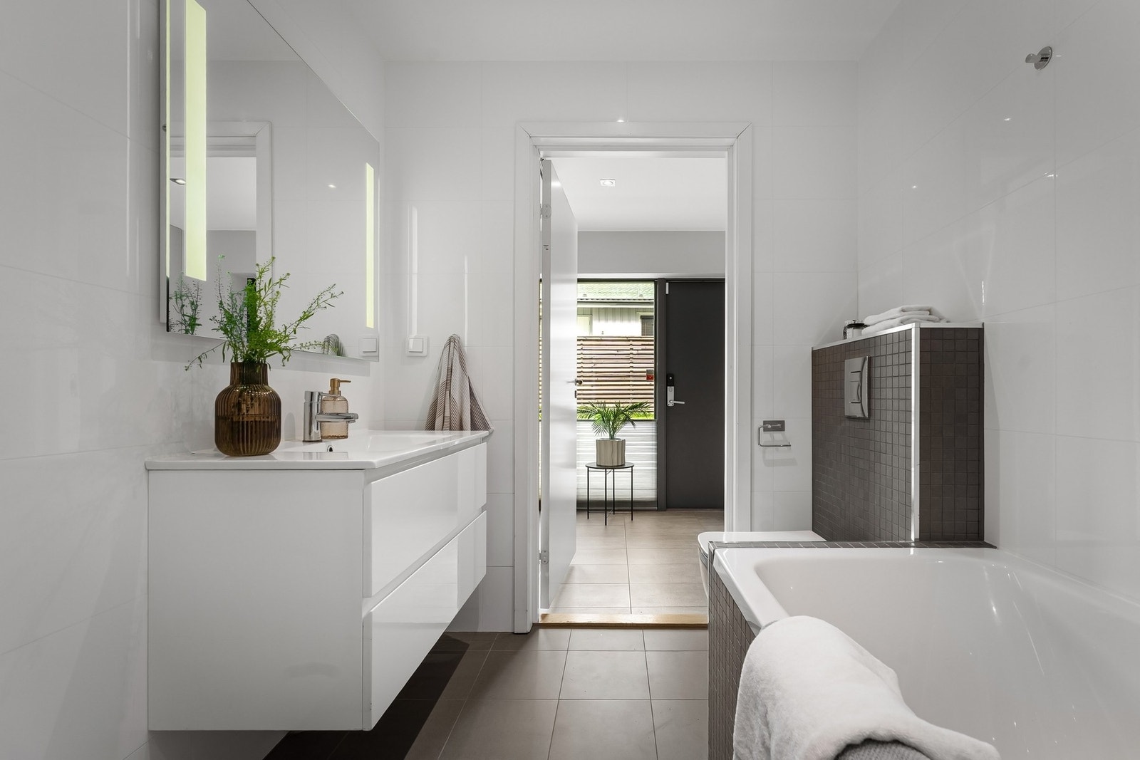 Badet har elektrisk gulvvarme og downlights i himlingen Galleribilde