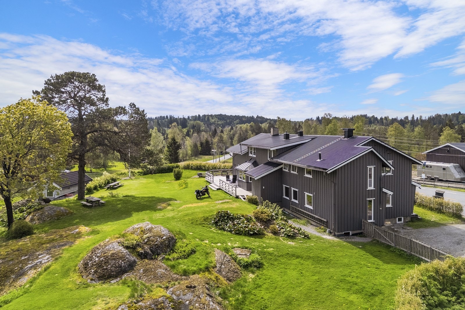 Skjermet fra veien finnes et romslig, solrikt hagerom med fjell i dagen og gode arealer som byr inn til lek og moro. Galleribilde