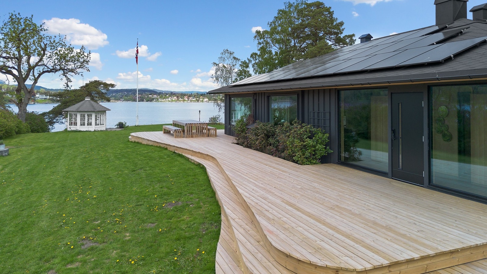 Romslig terrasse med flere soner for avslapning og sosiale sammenkomster Galleribilde