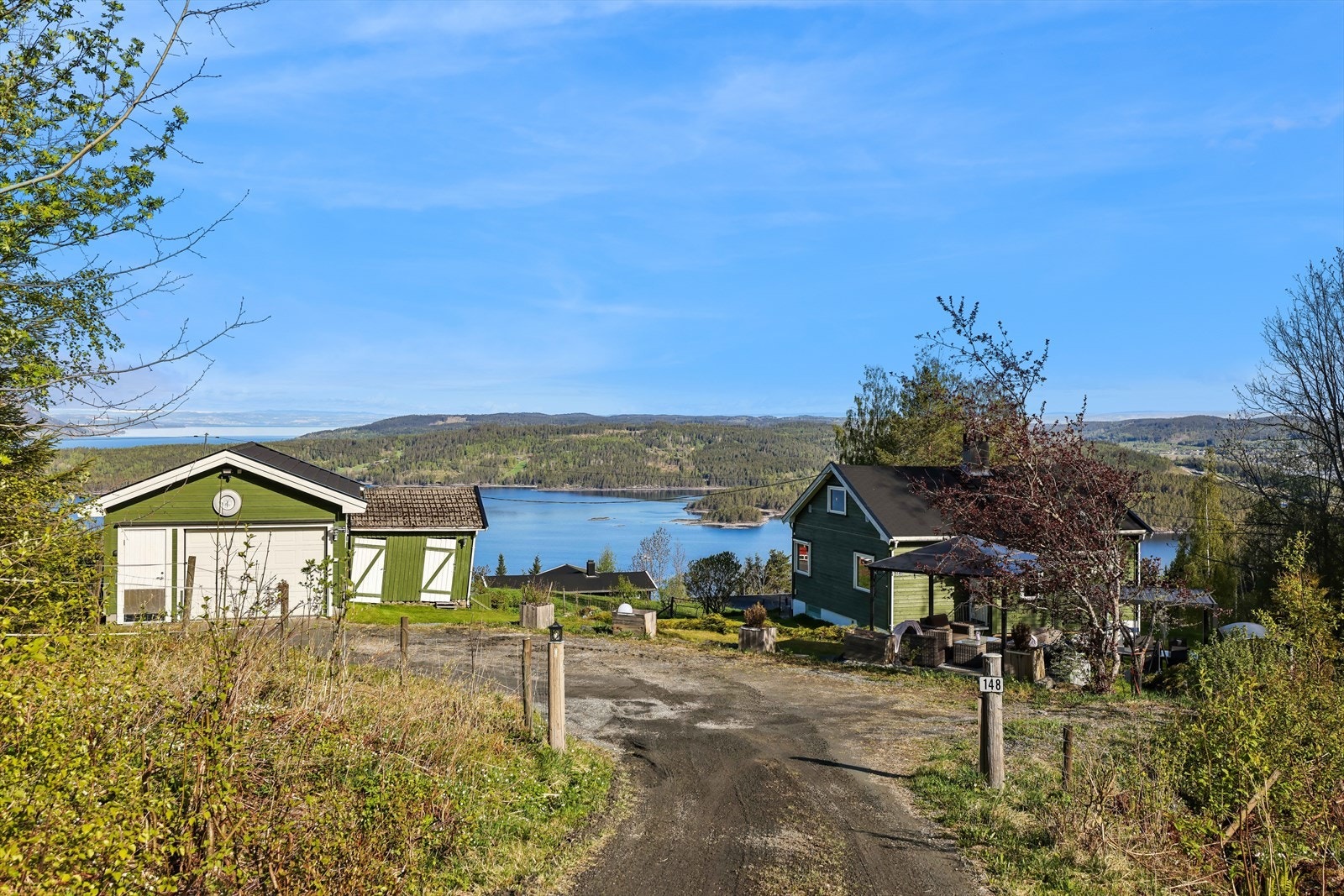 Enebolig fra 1947 på en skrående tomt med garasje fra 2014 og et eldre uthus. Galleribilde
