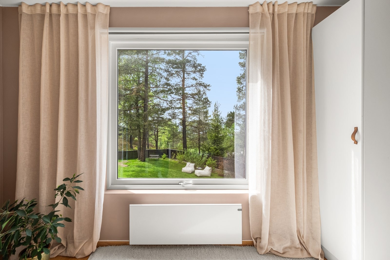 Stort vindu som slipper inn rikelig med naturlig lys og gir nydelig utsikt mot uteområdet. Galleribilde